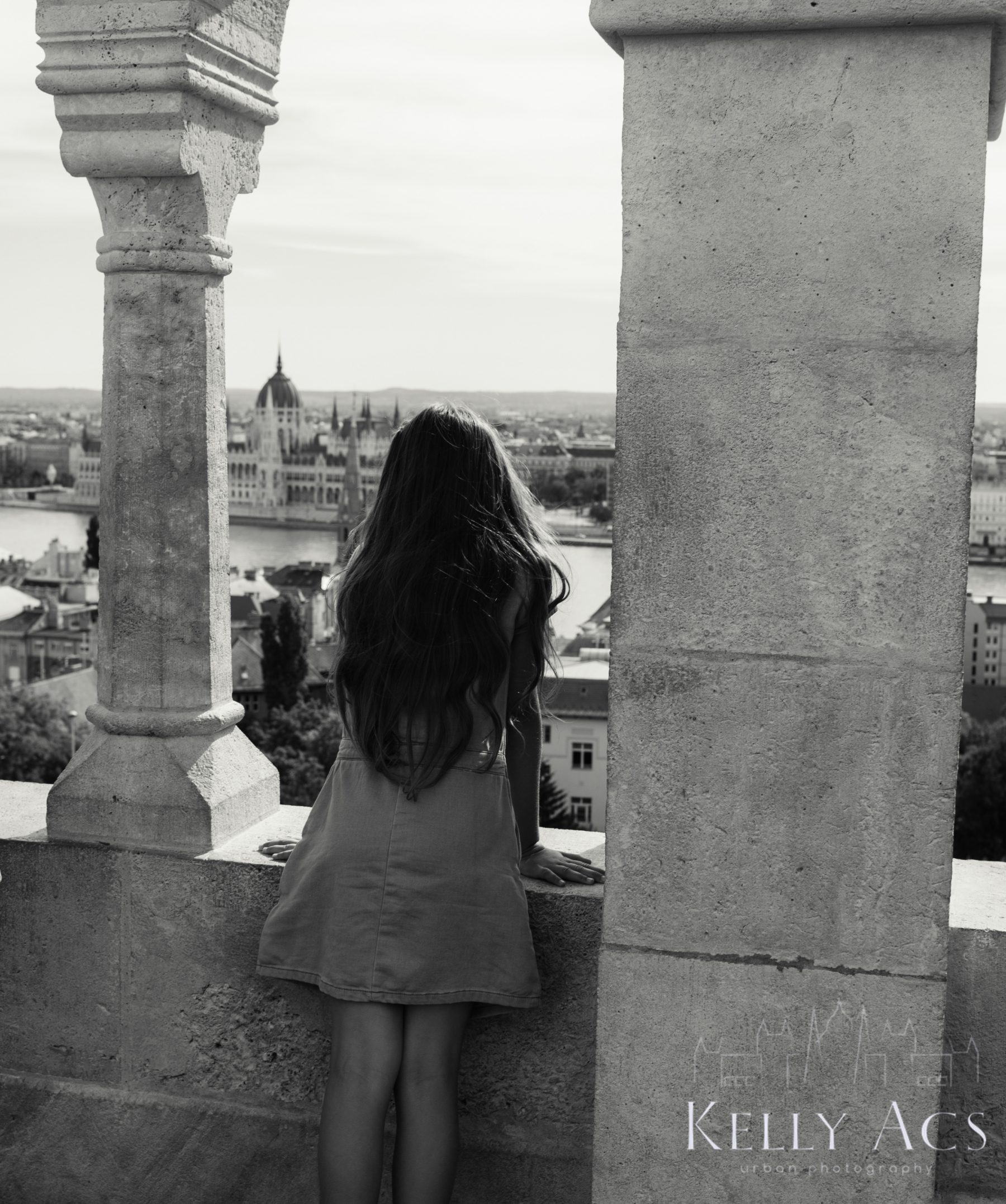 black and white image of girl overlooking city