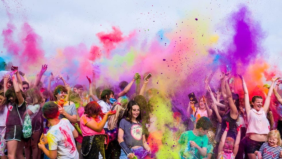 colorful powders thrown by crowd