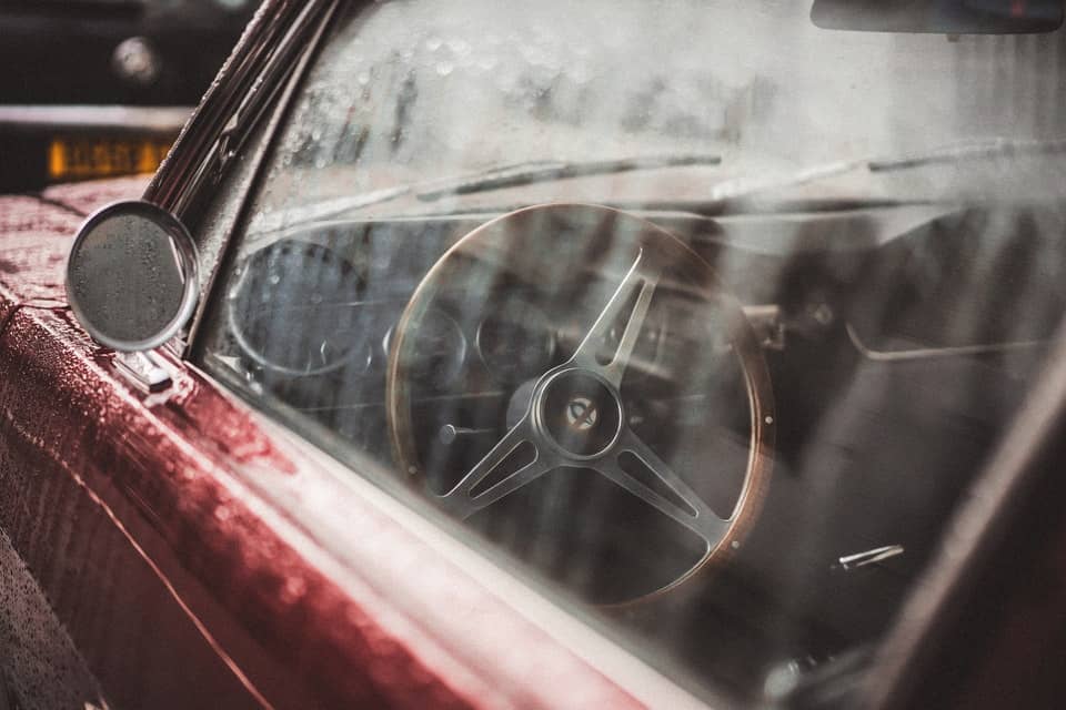 steering wheel of red car shot through window