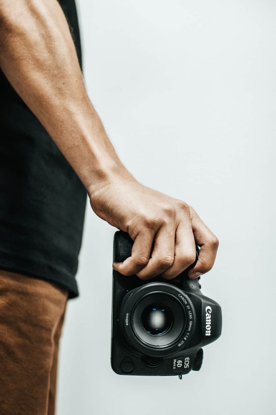 man holding camera at waist level