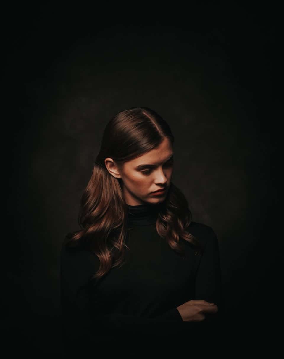 woman in front of black background